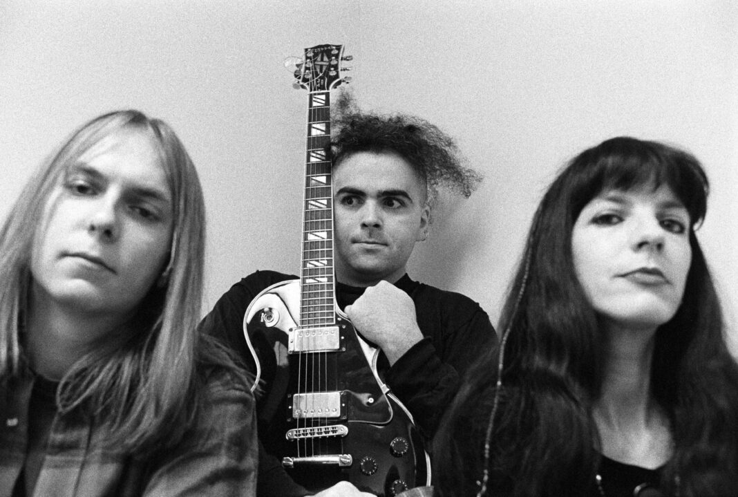LONDON - OCTOBER 30: Posed group portrait of The Melvins at Atlantic Records in London, England on October 30 1991. Left to right are Dale Crover, Buzz Osborne and Lori Black.